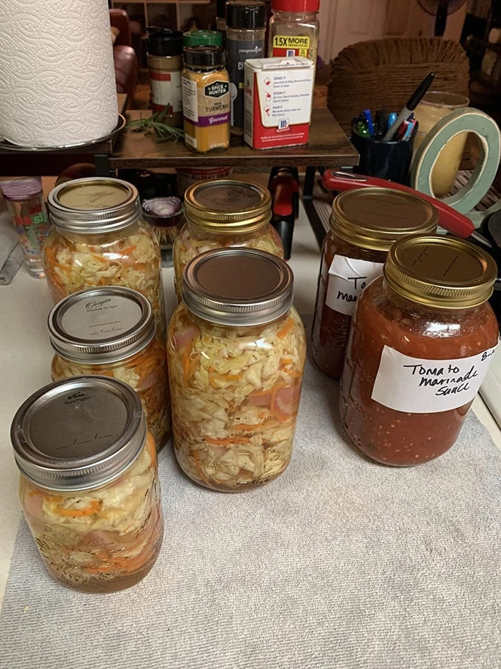 Mason jars filled with homemade salsa and pickled vegetables